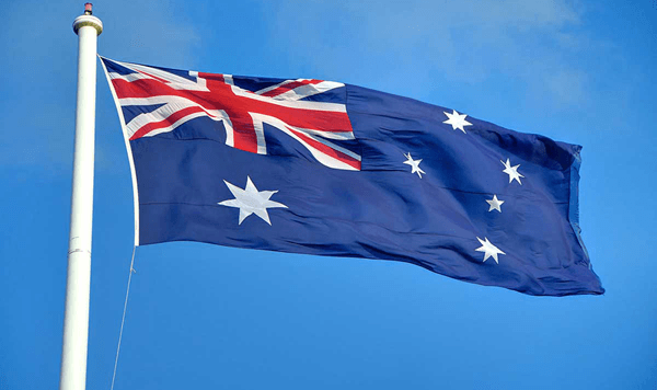Which country's flag features the Union Jack in the top left corner, a large seven-pointed star, and small stars representing a constellation?