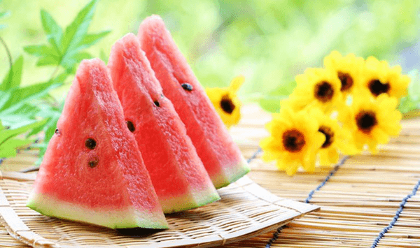 Which large summer fruit features a green-and-black striped rind and juicy red flesh filled with dark seeds?
