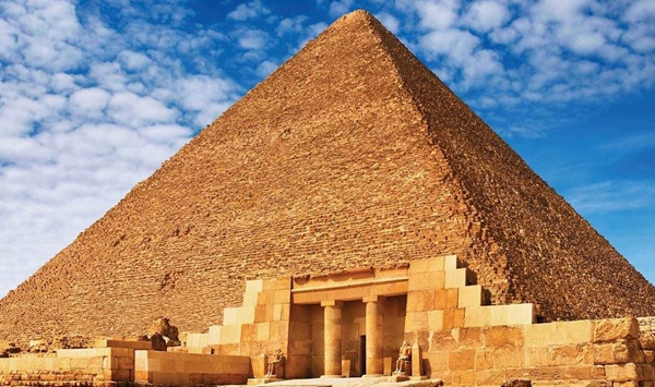 Located on the outskirts of Cairo, which of the Great Pyramids of Giza is the largest and also the oldest, standing as the last surviving wonder of the ancient world?