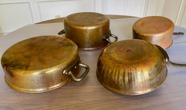 What common household pantry condiment did old-timers use to polish tarnished copper pots and brass until they gleamed?