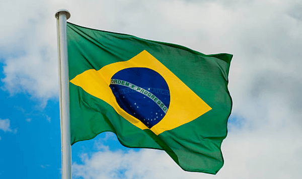 Which country's flag is green with a large yellow diamond in the center, containing a blue globe with white stars?