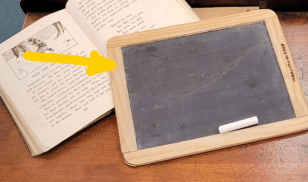 What historical classroom object is indicated by the arrow?
