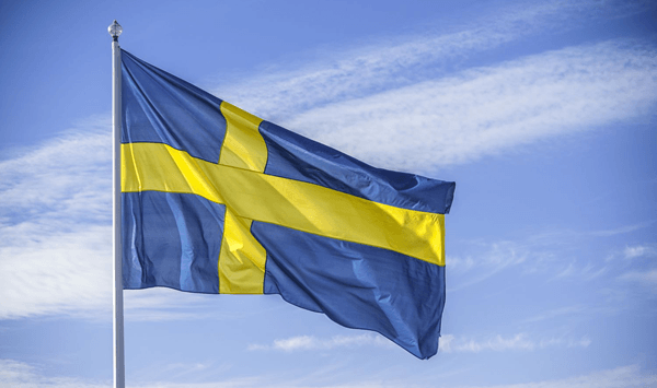 Which country's flag features a blue background with a yellow Scandinavian cross?