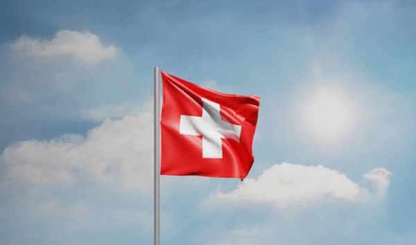 Which country's flag is a perfect red square with a white cross in the center?