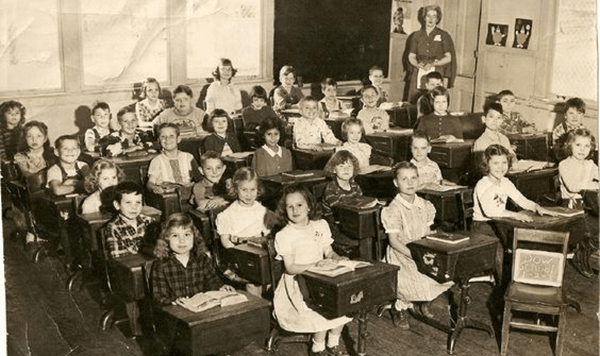 Before the first period bell rang, where did students gather each morning for roll call, announcements, and last-minute homework prep?