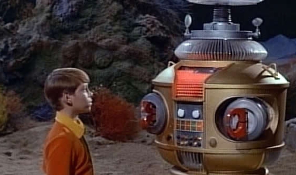 In the 1960s sci-fi adventure Lost in Space, what was the official designation of the family's iconic metallic guardian?
