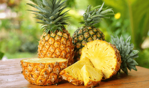 Which tough, spiky tropical fruit features a prickly outer shell and a crown of stiff green leaves on top?
