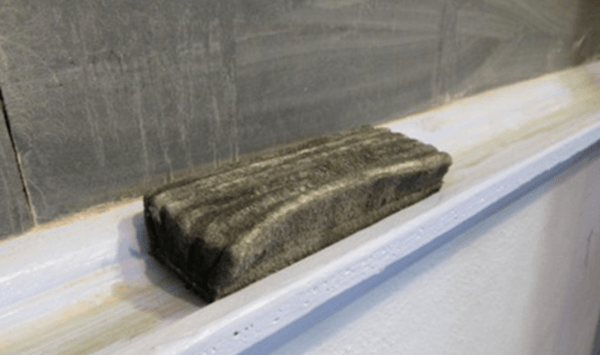 What everyday vintage classroom accessory resting on the ledge is shown here?
