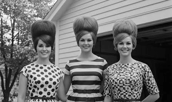 What classic hairstyle required girls to use huge plastic rollers and endless squirts of Aqua Net hairspray?