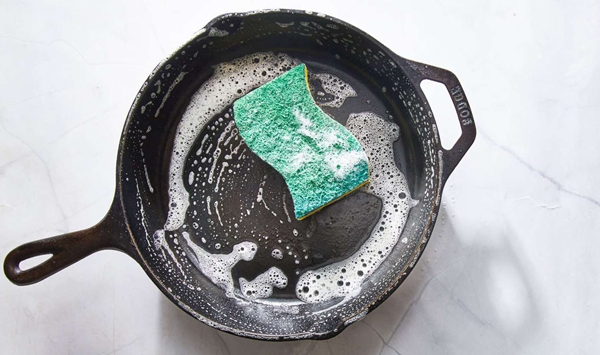 Why do many classic home cooks insist you should never use dish soap on a cast-iron skillet, and what does modern cooking science say?