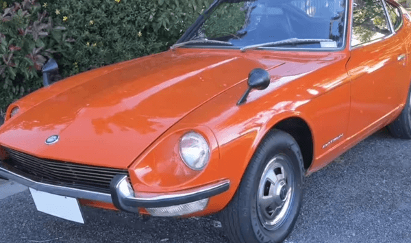 Which Japanese sports car offered a more affordable alternative to the prestigious Jaguar E-Type?