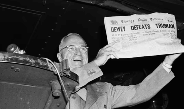 Which presidential election generated the famous photograph of a smiling winner holding up a newspaper headline erroneously reading 'DEWEY DEFEATS TRUMAN'?