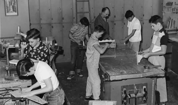In 1960s Shop Class, what popular wooden utensil did almost every student carve on a lathe?