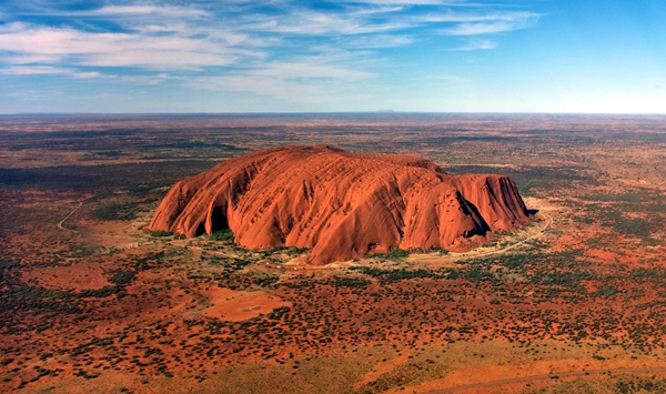What is the sacred Aboriginal name for the giant red sandstone formation in central Australia, formerly known primarily as Ayers Rock?