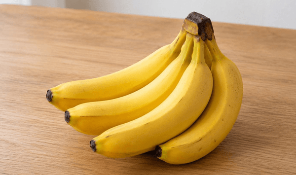 Which tropical fruit is elongated, has a yellow peel when ripe, and is soft and sweet on the inside?