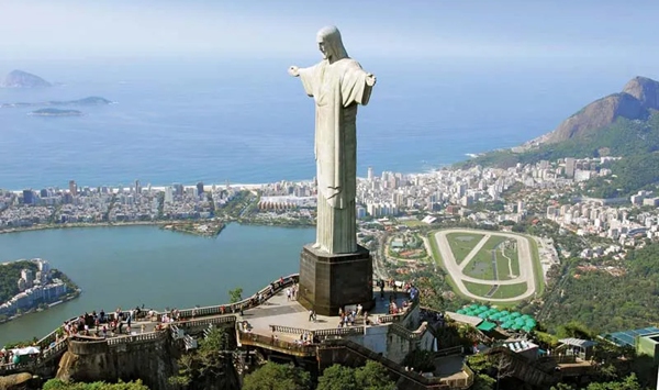 Standing 30 meters (98 ft) tall atop Corcovado Mountain in Rio de Janeiro, what is the name of this world-famous Brazilian landmark?