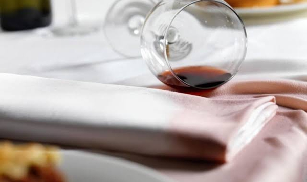 If red wine gets spilled on a white tablecloth, what inexpensive kitchen staple should be dumped on the spot immediately to absorb the liquid?