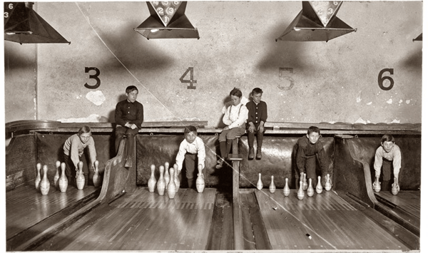 Before machines took over, who manually reset bowling pins?