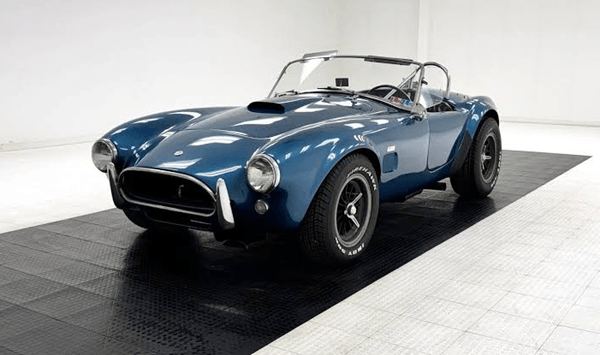 Which sports car was created when an American performance guru paired a lightweight British chassis with a powerful V8 engine?