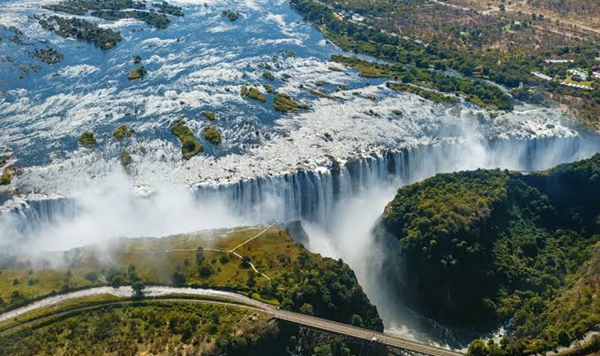 Located on the border between Zambia and Zimbabwe, Victoria Falls produces a mist that rises up to 1,600 feet. What is its local indigenous name?